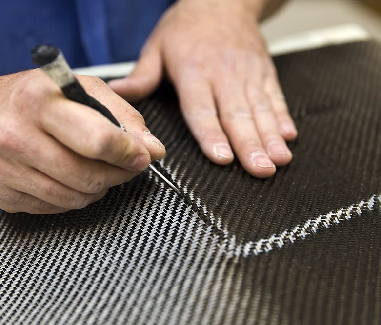 Man cutting carbon fiber